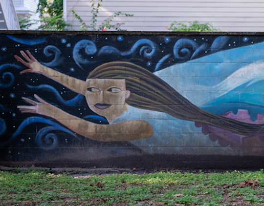 A mural of a woman flying.